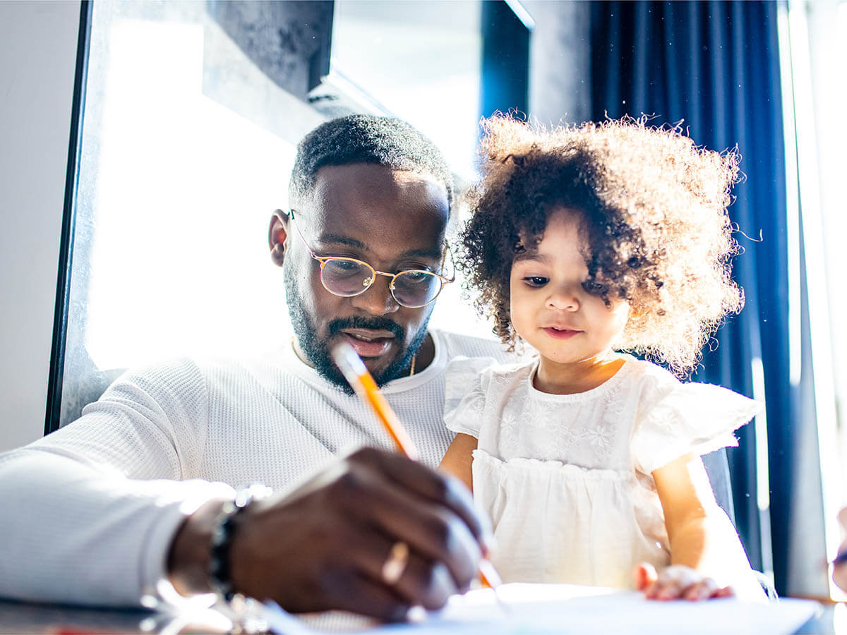 Single Dad Doing Schoolwork with Daughter